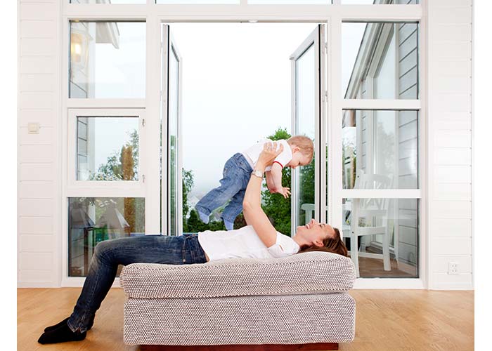New windows highlands ranch, woman holds baby next to new custom window installation